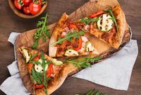 pizza-slices-wooden-board-top-view